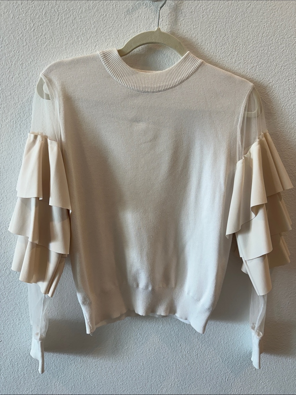 White knit sweater with ruffle sleeves